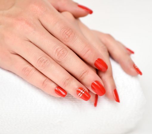Manicure - Beautiful manicured woman's nails with red nail polis